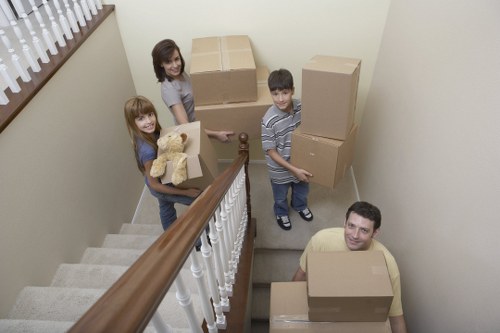 Professional movers carrying items in a Swisscottage residential area